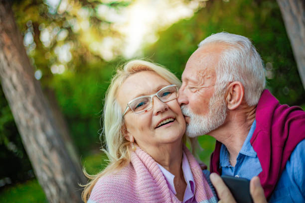 istock Senior couple enjoying in park 1157441047