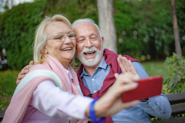 istock Senior couple enjoying in park 1157441110