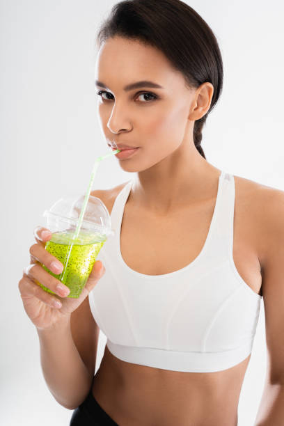 istock Young lady enjoying of drinking juice cocktail 1157441138
