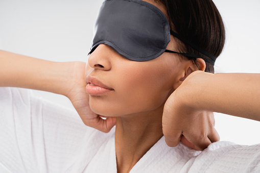 Sleepy Woman With Blindfolds On Eyes Stretching Stock Photo