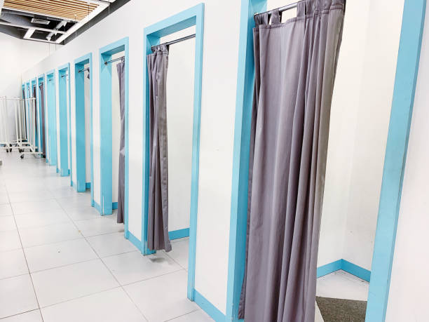 istock Empty fitting rooms with grey curtains and white walls 1157441438