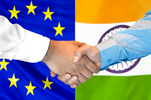 Business handshake on the background of two flags. Men handshake on the background of the European Union and India flag. Support concept