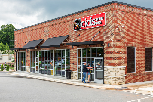 Statesville, NC, USA-June 19, 2019: A local Cicis Beyond Pizza restaurant, with customers entering the building.