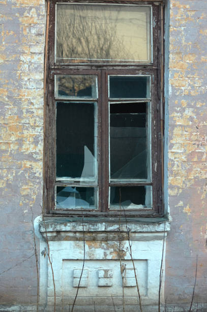 istock Old window with wooden frame and broken glass. 1157443723