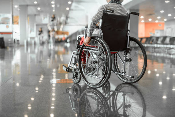 istock Mature lady on disabled carriage in hall 1157444914