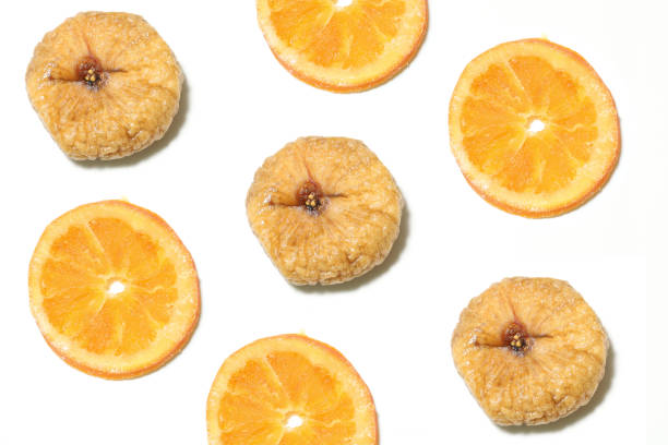 istock dried figs and dried oranges in a white background 1157445803