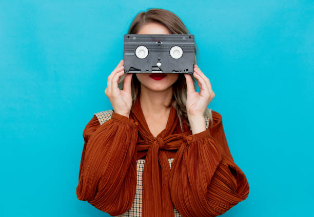 istock Young woman with VHS cassettee 1157445946