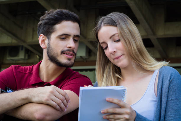 istock Group of  University students studying together outdoors 1157446175