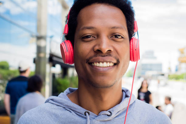 istock Young man enjoying music outdoor. 1157446191
