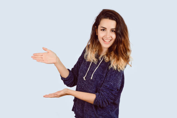 istock Young woman showing something. 1157446220