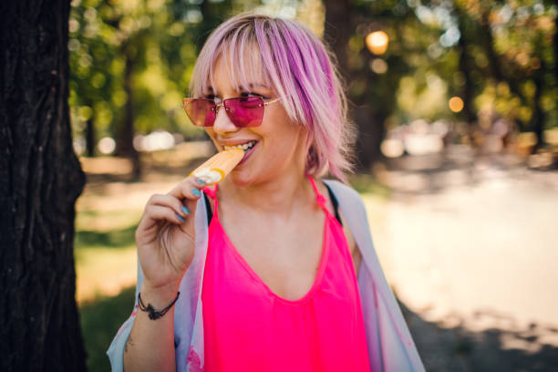 istock Young Woman Eating Ice Cream 1157446248