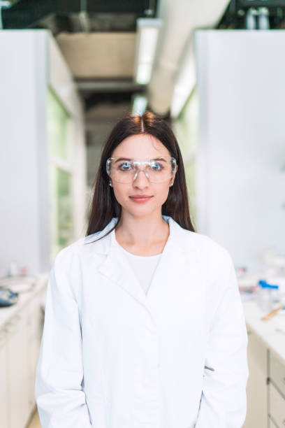 istock Female scientist in protective eyewear and white coat 1157447813