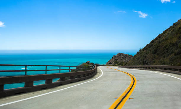 Highway Curves Around Corner with Ocean Background stock photo