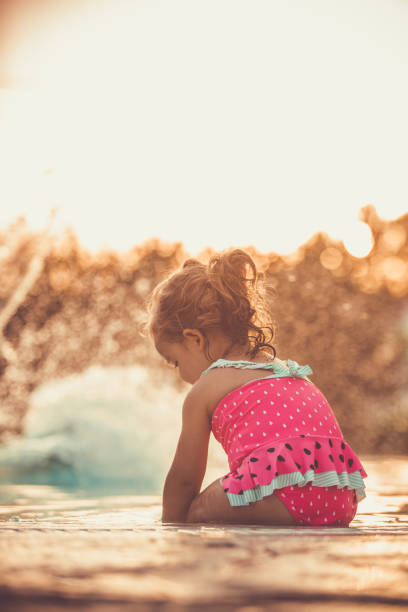 istock Playing in the swimming pool during sunset 1157458840