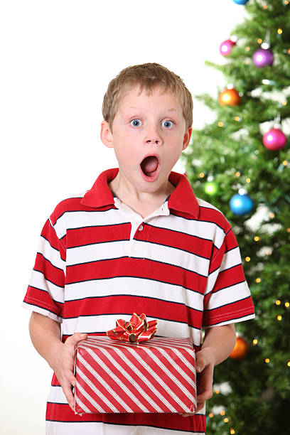 surprised boy with gift stock photo