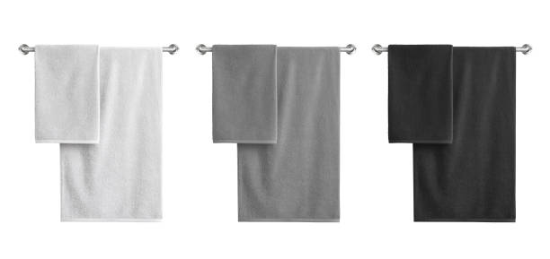 istock White, black and grey cotton terry towels hanging on a rail isolated 1157464097
