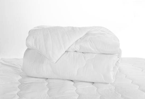 istock Rolled white soft duvet on the bed against the white background 1157464212