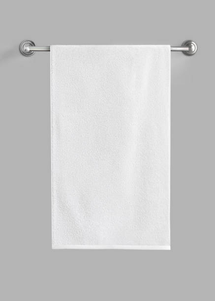 White cotton terry towel hanging on the rail isolated. White towel against the gray background. White cotton terry towel hanging on the rail isolated. White towel against the gray background. Ready for mock up. guest bathroom stock pictures, royalty-free photos & images