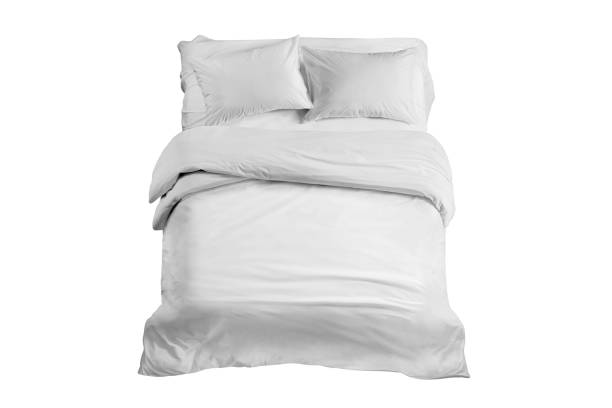 istock White bed isolated, white bed linen isolated, bed with pillows isolated 1157464858