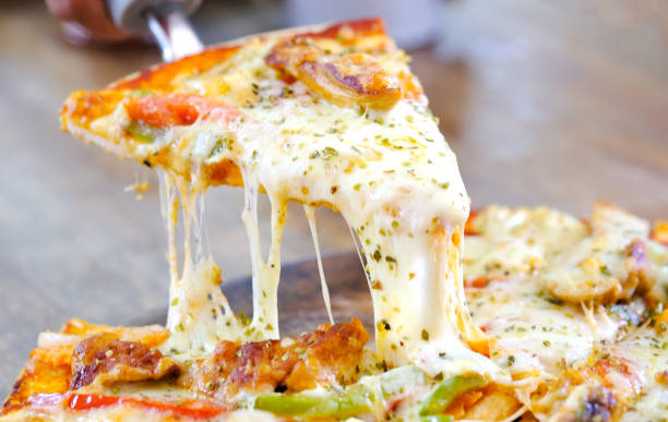 istock Chef's hands are cutting pizza with cheese. From the pizza tray 1157467863