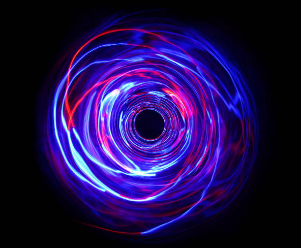 istock LED violet and blue light spinning in the dark. 1157468677