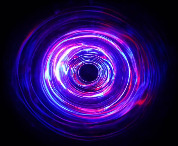 istock LED violet and blue light spinning in the dark. 1157468695