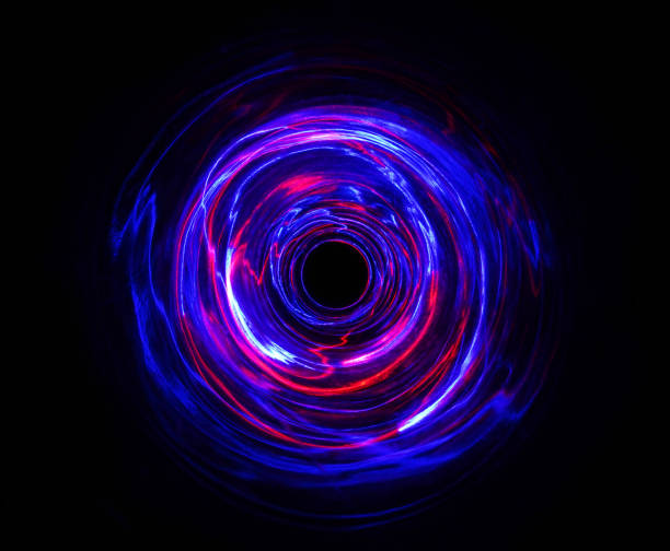 istock LED violet and blue light spinning in the dark. 1157468698