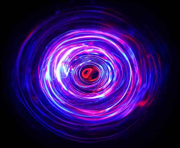istock LED violet and blue light spinning in the dark. 1157468699