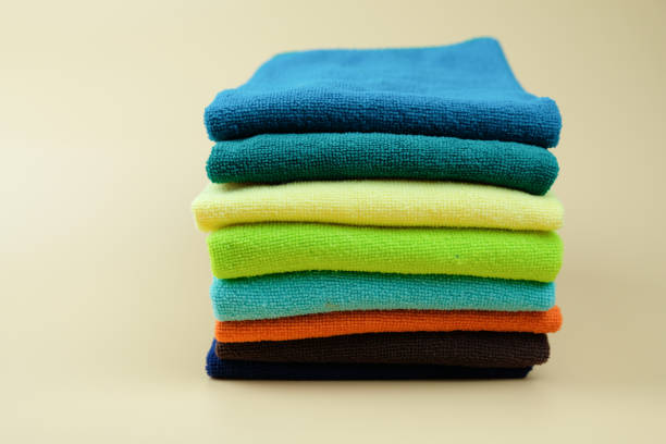 istock Set of multicolored folded towels piled on in stack close up with selective focus 1157476093
