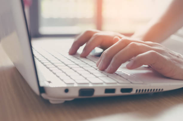 istock Business economic and technology working concept. Close up woman hand using keyboard and personal computer on wood table background. Shallow depth of field. Vintage tone filter effect color style. 1157477287