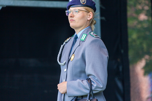 Augustdorf / Germany - June 15, 2019: German female soldier in full dress uniform walks on a stage at Day of the Bundeswehr 2019.
