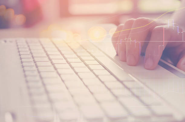 istock Business economic and technology working concept. Woman hand using notebook double exposure with graph money stock trading and blur bokeh light background. Vintage tone filter effect color style. 1157478148