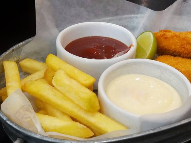 istock Close up fish and chips with mayonnaise sauce and ketchup 1157479120