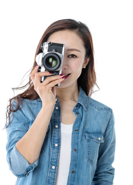 istock Beautiful woman holding a SLR camera on white background 1157485607