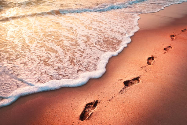 istock Foot print on sand beach with smooth wave abstract texture background. Summer vacation and travel holiday concept. Vintage tone filter effect color style. 1157486338