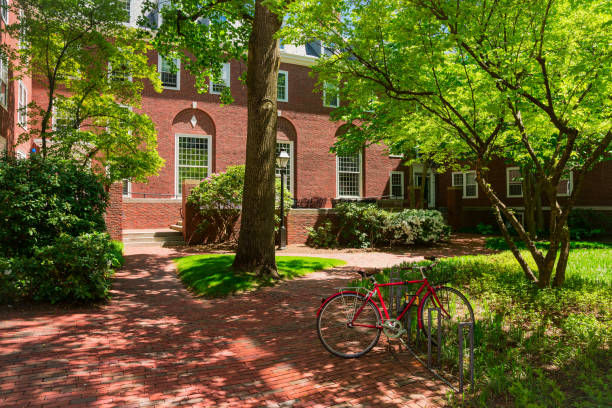 College dorm Red brick college dormitory with a bicycle and trees. dorm room photos stock pictures, royalty-free photos & images