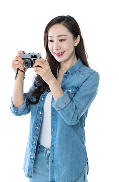 istock Beautiful woman holding an old camera on white background 1157486406