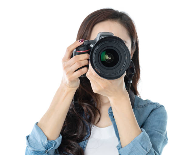 istock Woman holding professional digital camera on white background 1157486501