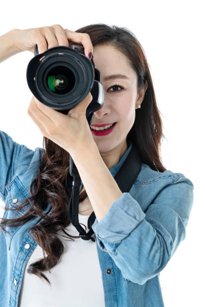 istock Woman holding professional digital camera on white background 1157486583