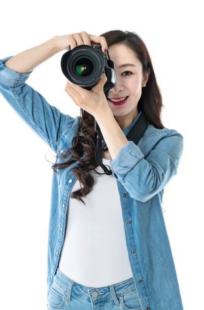 istock Woman holding professional digital camera on white background 1157486648