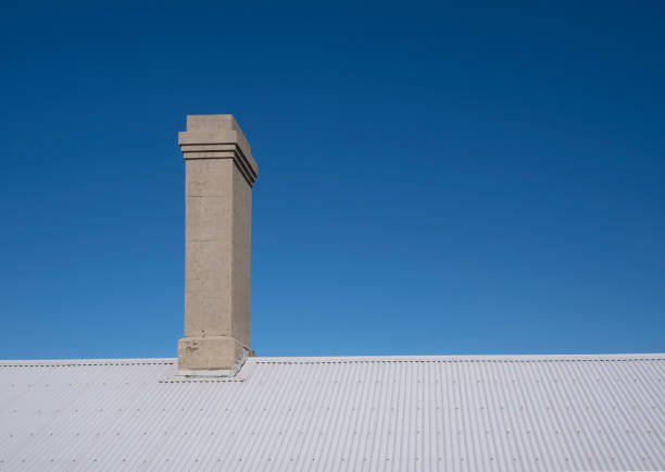 istock Old chimney on corrugated iron roof 1157490399