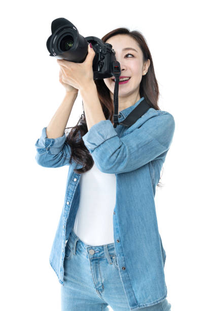 istock Woman holding professional digital camera on white background 1157490538
