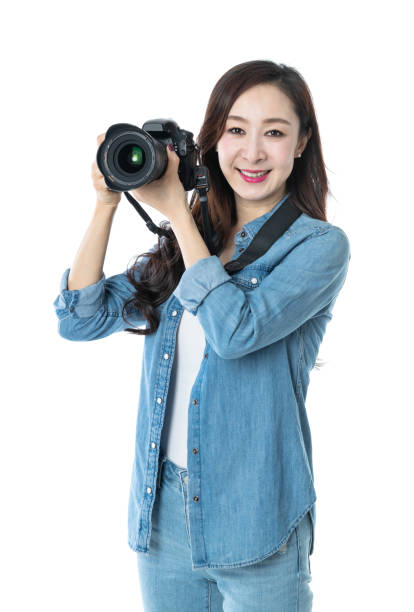 istock Woman holding professional digital camera on white background 1157490610