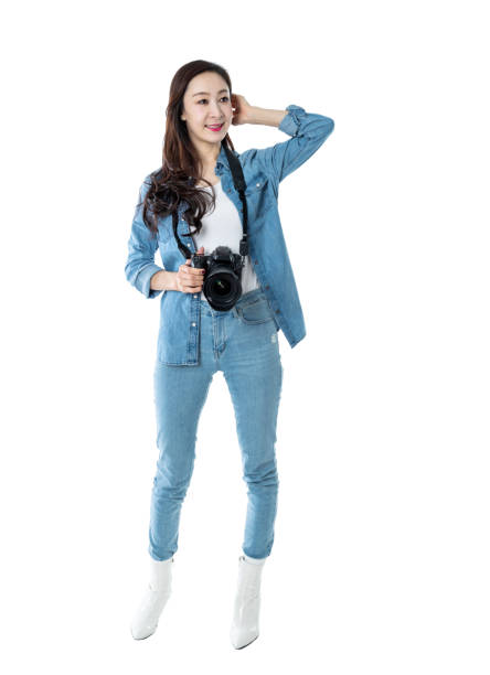 Woman holding professional digital camera on white background.