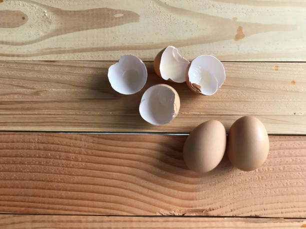 istock two fresh organic chicken eggs and four eggshells on natural rubber wood table in studio shot 1157491460