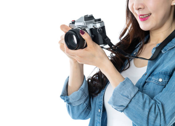istock Woman holding a SLR camera on white background 1157491493