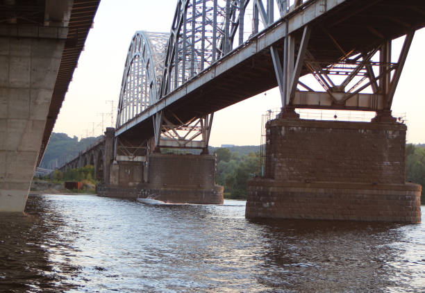 istock modern motorboat sails under the old river bridge 1157492578