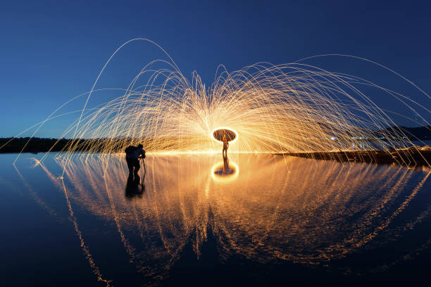 istock Showers of hot glowing sparks from spinning 1157493396