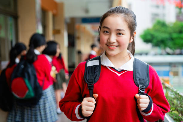 istock Smiling female high school student in corridor 1157498236