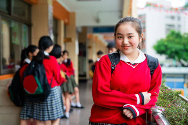 istock Schoolgirl leaning on railing in corridor 1157498247